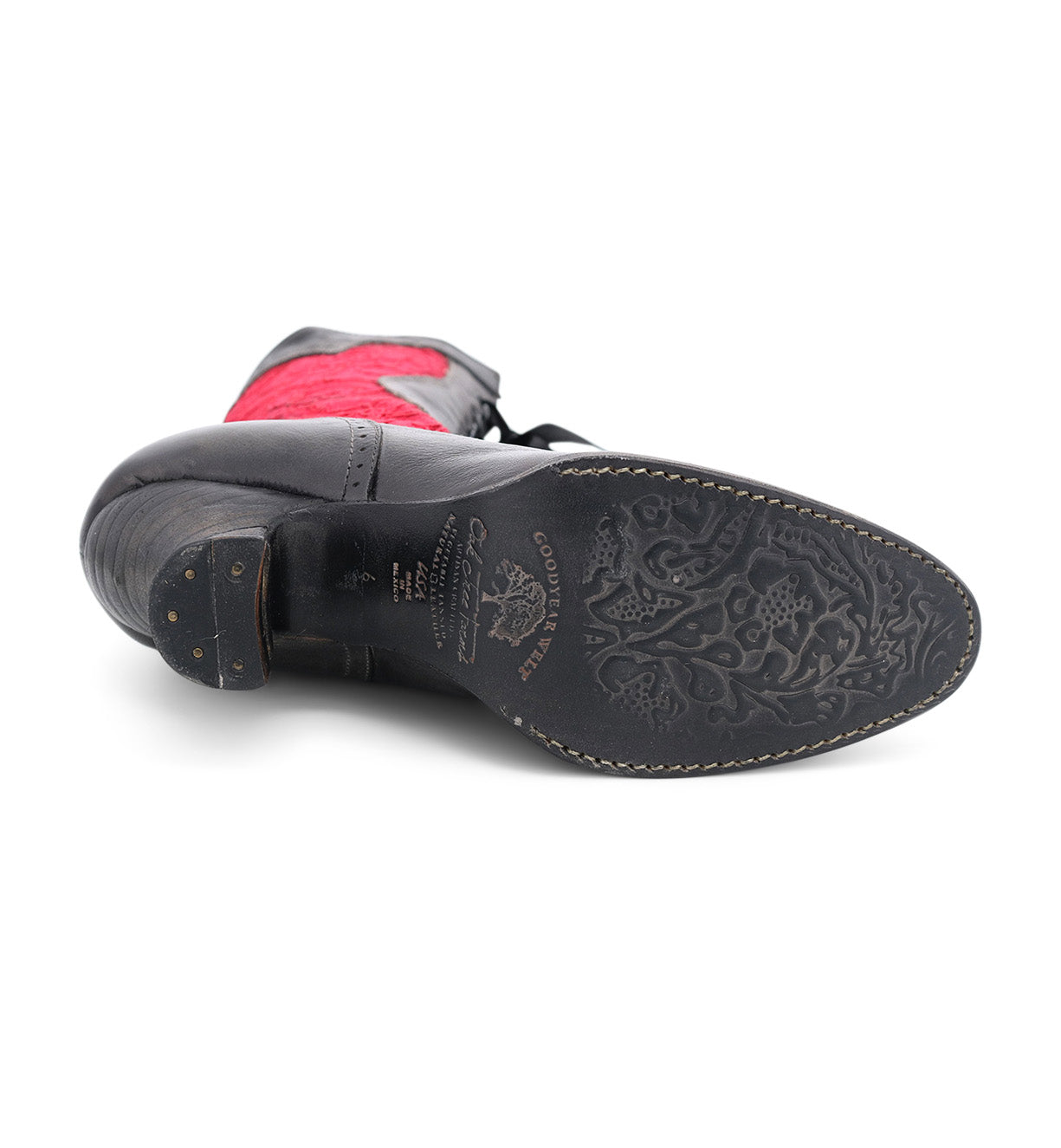 A pair of charming black and red handmade Abigale shoes with an Oak Tree Farms red sole.