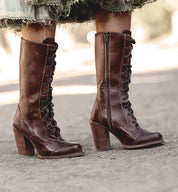 A woman wearing Oak Tree Farms' Ariana leather boots and a skirt.