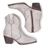 A pair of Baila white cowboy boots with a wooden heel made by Oak Tree Farms.