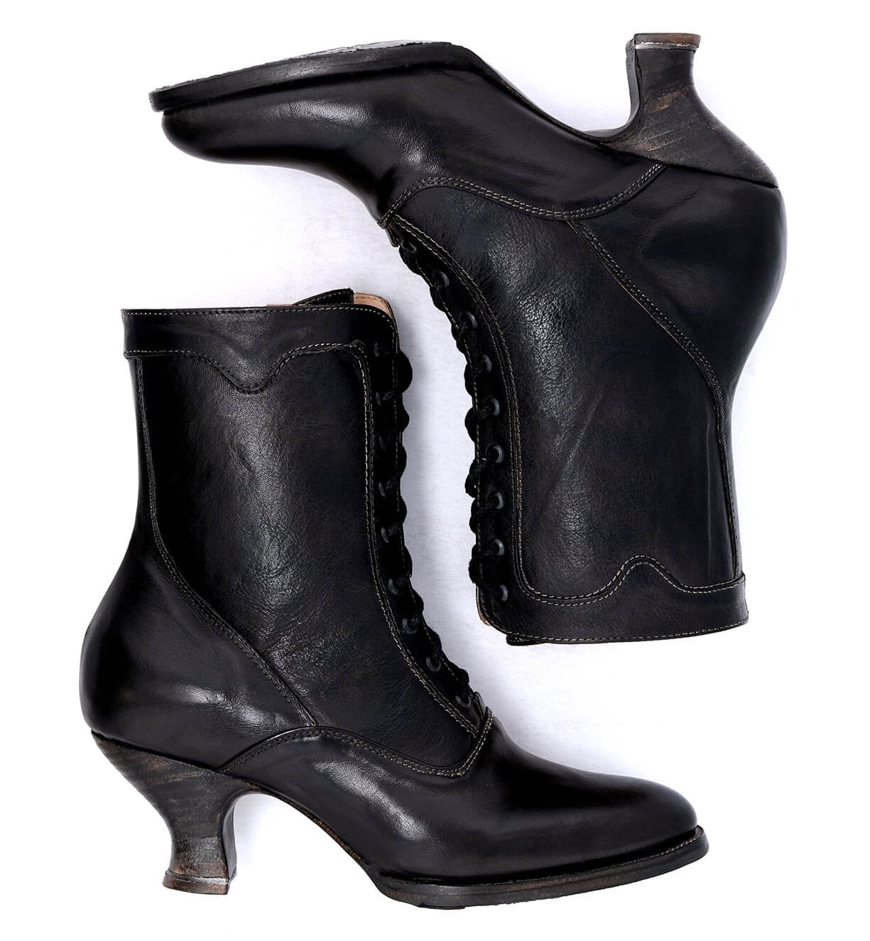A pair of Oak Tree Farms Eleanor hand dyed black leather boots, epitomizing Victorian style and offering uncompromising quality, showcased on a pristine white background.