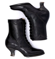 A pair of Oak Tree Farms Eleanor hand dyed black leather boots, epitomizing Victorian style and offering uncompromising quality, showcased on a pristine white background.