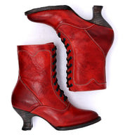 A pair of Oak Tree Farms Eleanor hand dyed red leather boots on a white background, showcasing uncompromising quality.