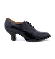 A women's black oxford shoe named "Janet" from the brand "Oak Tree Farms" with a lace-up design and spooled heel, set on a white background.