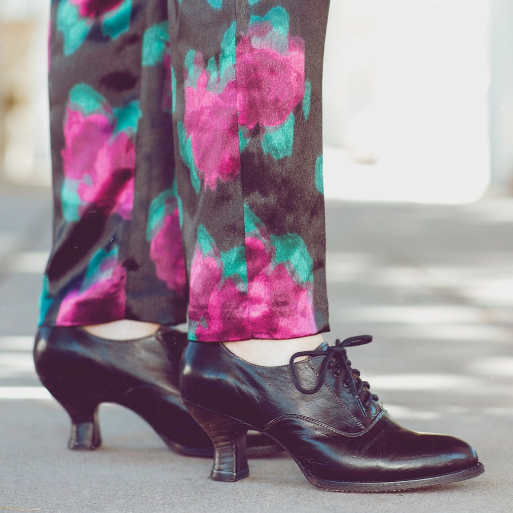 A woman sporting a neutral look with black pants and Oak Tree Farms Janet lace-up front leather shoes.