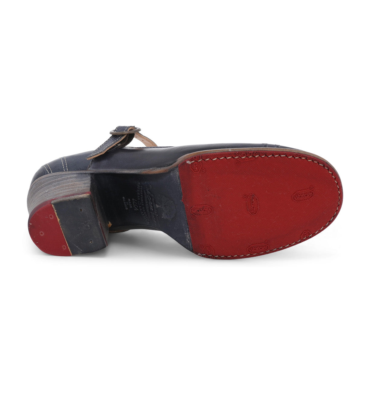 A pair of Twigley Mary Jane style shoes with red and blue soles, made of leather by Oak Tree Farms.