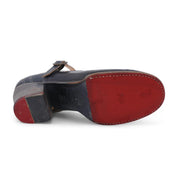 A pair of Twigley Mary Jane style shoes with red and blue soles, made of leather by Oak Tree Farms.