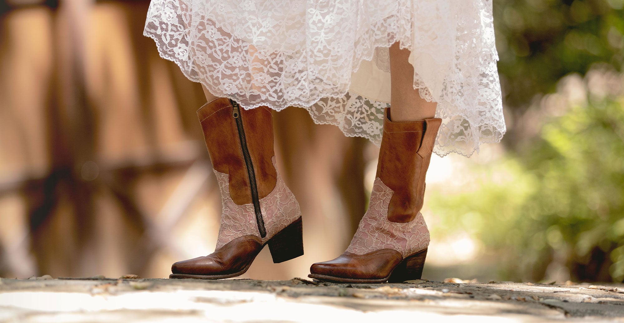 A woman wearing a white dress and brown boots.