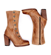 A pair of Oak Tree Farms women's tan leather ankle boots named Amelia. Made with full grain leather and featuring a Goodyear leather welt construction, these stylish boots have a touch of steampunk flair.