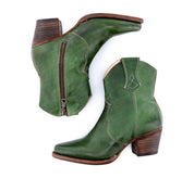 A pair of Baila green cowboy boots with a wooden heel by Oak Tree Farms.