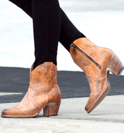 A woman wearing a pair of Oak Tree Farms Baila cowboy boots.