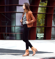 A woman wearing a Baila jacket by Oak Tree Farms and black jeans.