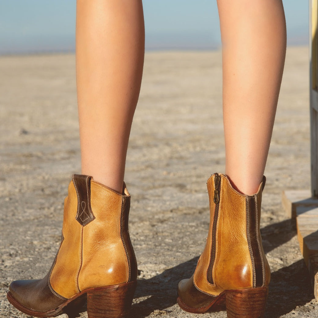 A woman wearing Baila cowboy boots by Oak Tree Farms in the desert.