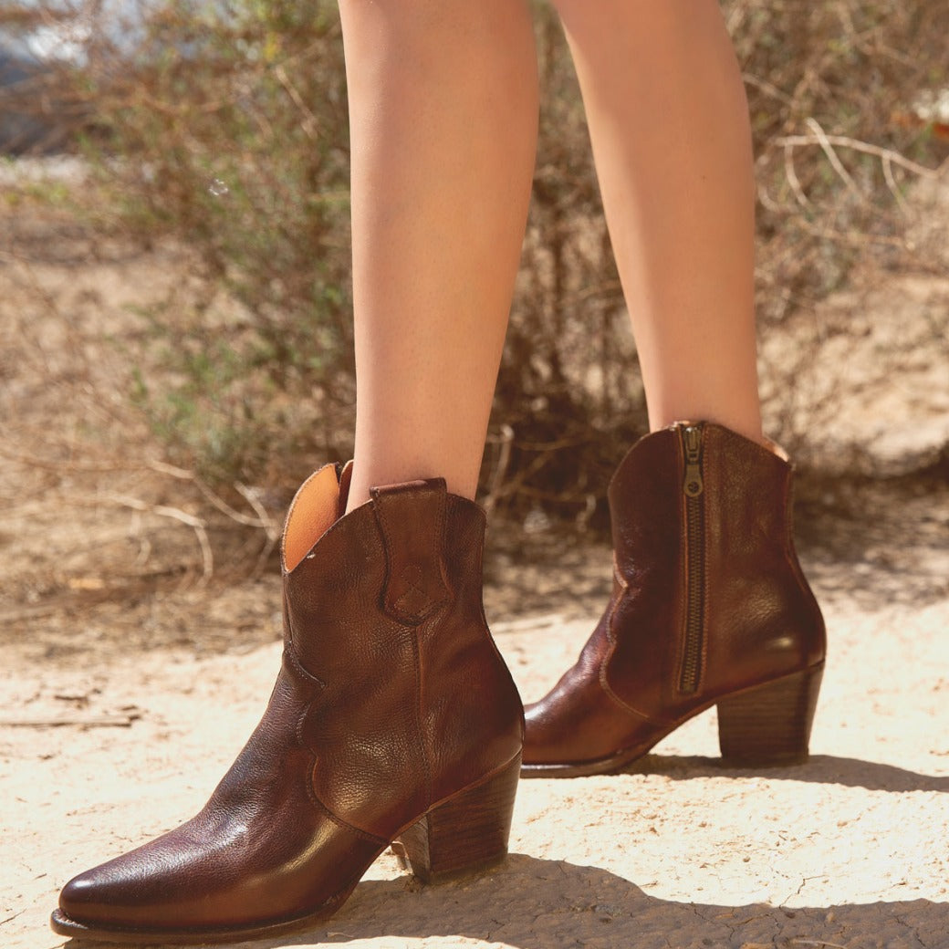 A woman wearing Oak Tree Farms' Baila cowboy boots in the desert.