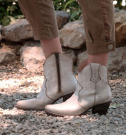 A woman wearing a pair of Oak Tree Farms Baila cowboy boots.