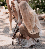 A woman petting a Baila horse.
