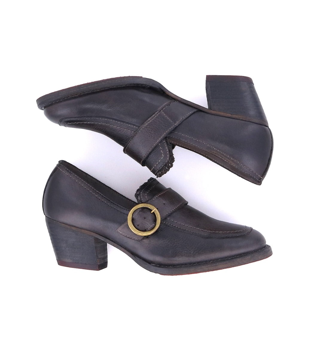 A pair of black leather Dyba shoes with a gold buckle, designed as heeled loafers for the fashion-savvy Diva, by Oak Tree Farms.