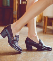 An Oak Tree Farms diva confidently strutting in a pair of stylish heeled loafers.