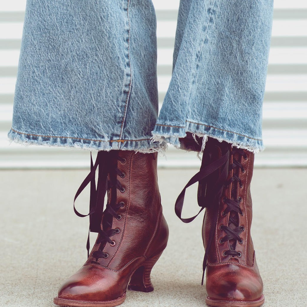 A woman's legs in Eleanor lace up boots by Oak Tree Farms, showcasing uncompromising quality.