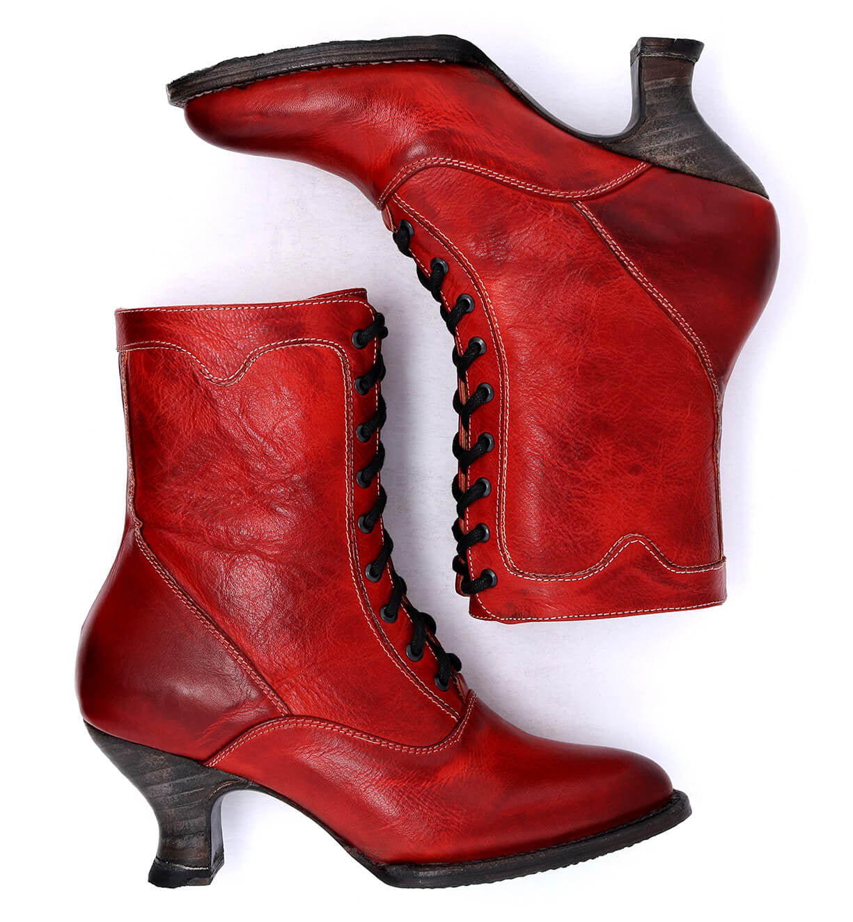 A pair of Oak Tree Farms Eleanor hand dyed red leather boots on a white background, showcasing uncompromising quality.