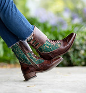 Oak Tree Farms, a woman wearing handcrafted leather lace-up riding boots in brown and green.
