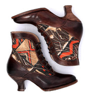 A pair of brown leather boots with an Oak Tree Farms Jacquelyn pattern on them.