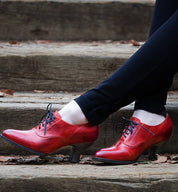 A woman wearing a pair of red leather Oak Tree Farms Janet shoes.