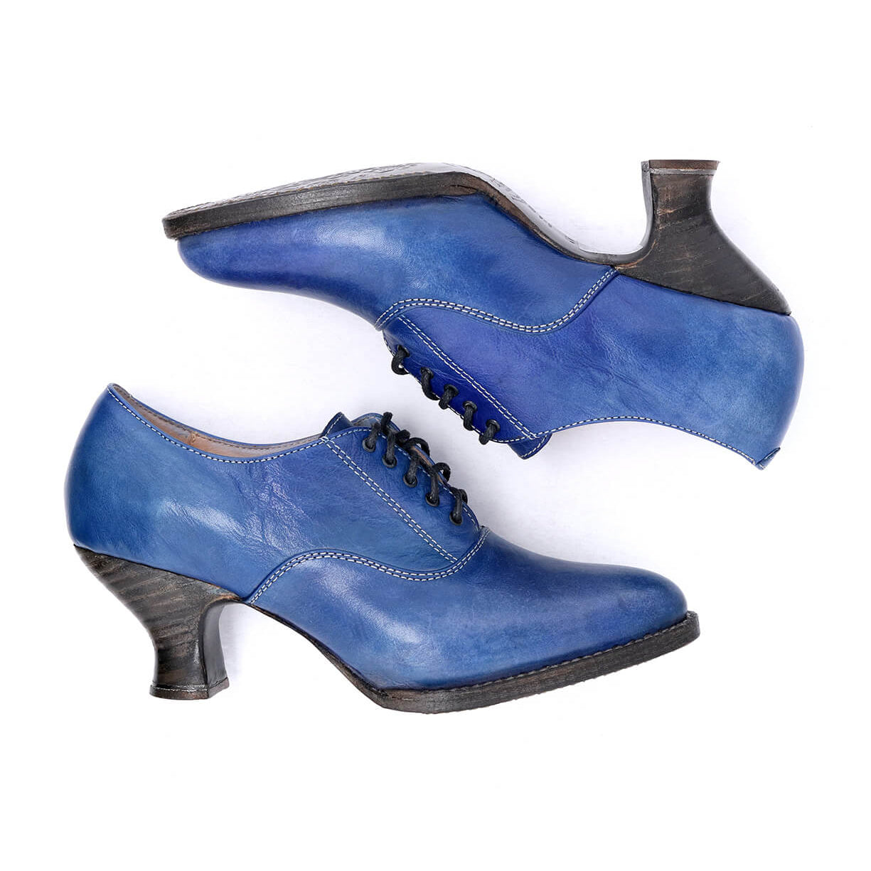 A pair of Janet Oak Tree Farms blue leather shoes with a lace-up front on a white background.