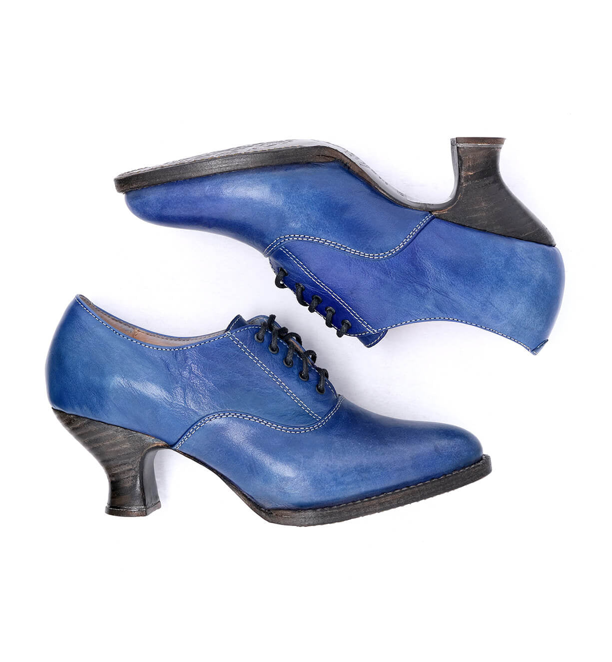 A pair of Janet Oak Tree Farms blue leather shoes with a lace-up front on a white background.