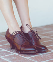 A woman's legs in a pair of Janet leather oxford shoes by Oak Tree Farms.