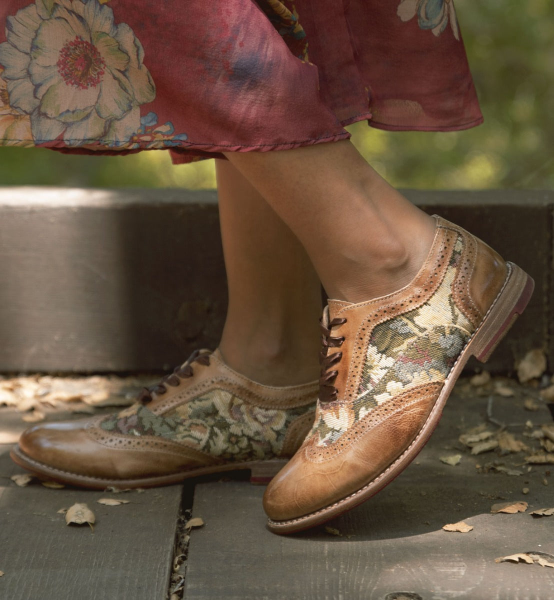 A woman displaying her Oak Tree Farms Maude leather wingtip oxford shoes in a comfortable floral dress.