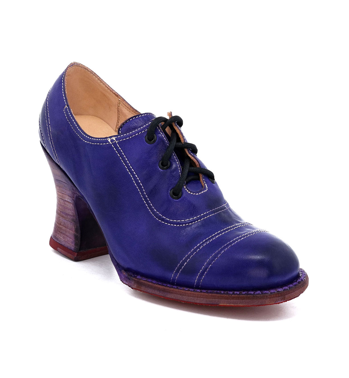 A women's blue Nanny shoe by Oak Tree Farms with a wooden heel, adding an enchanting touch to any outfit.
