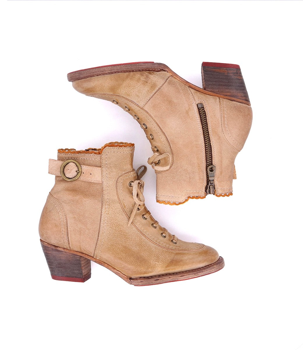 A pair of Oak Tree Farms tan leather heeled boots on a white background.