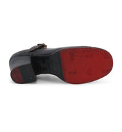 A pair of Twigley black leather shoes with red soles on a white background by Oak Tree Farms.