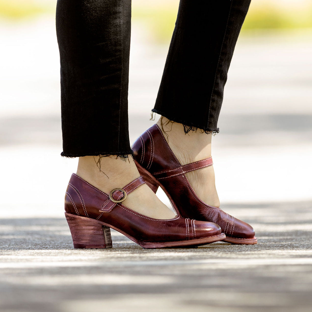 A woman wearing a pair of burgundy Oak Tree Farms mary jane shoes in Twigley style.