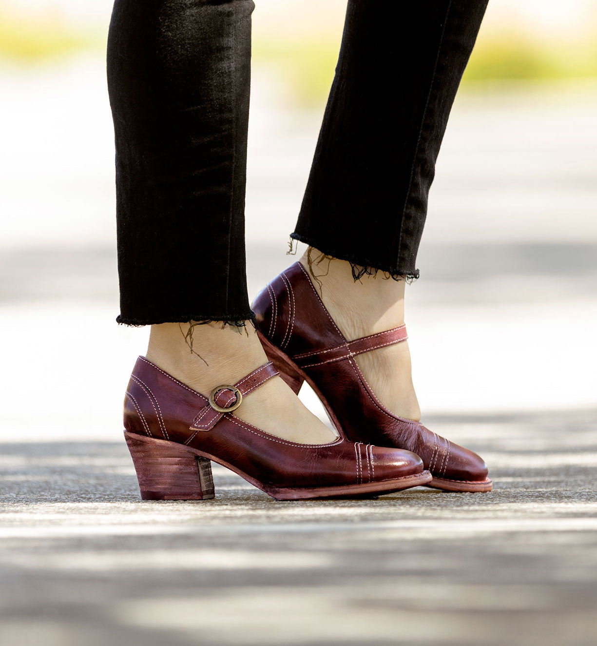 A woman wearing a pair of burgundy Oak Tree Farms mary jane shoes in Twigley style.