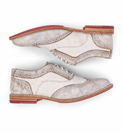 A comfortable pair of Oak Tree Farms Maude leather wingtip oxford men's shoes on a white background, perfect for any wardrobe.